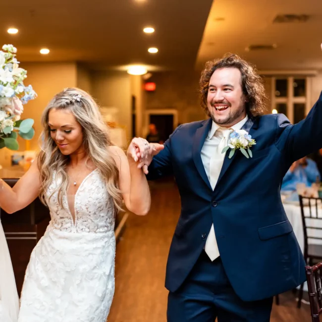 bride and groom - man and woman holding hands and dancing after getting married at at 5eleven Palafox in pensacola fl