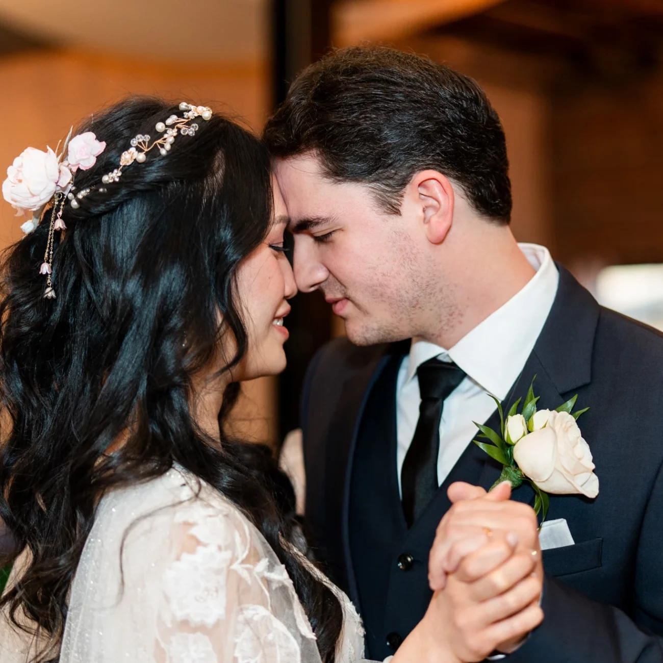 a man and woman holding hands sharing first dance at wedding at Navarre Beach Wedding House