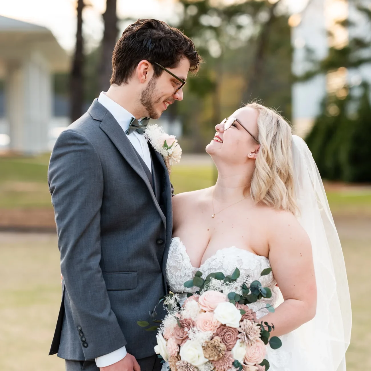 a man and woman in wedding attire looking into each others eyes in Navarre, FL - KDH Weddings