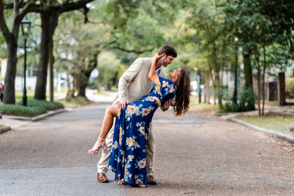 19 Unique Engagement Photo Locations in Mobile, AL (2025 Update) 1 a man holding a woman in a blue dress Charming Engagement photo Shoot in Mobile, AL at springhill college