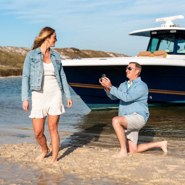 Ethan proposes to Kim on pensacola beach, Ethan on one knee, Kim turns around baffled and surprised