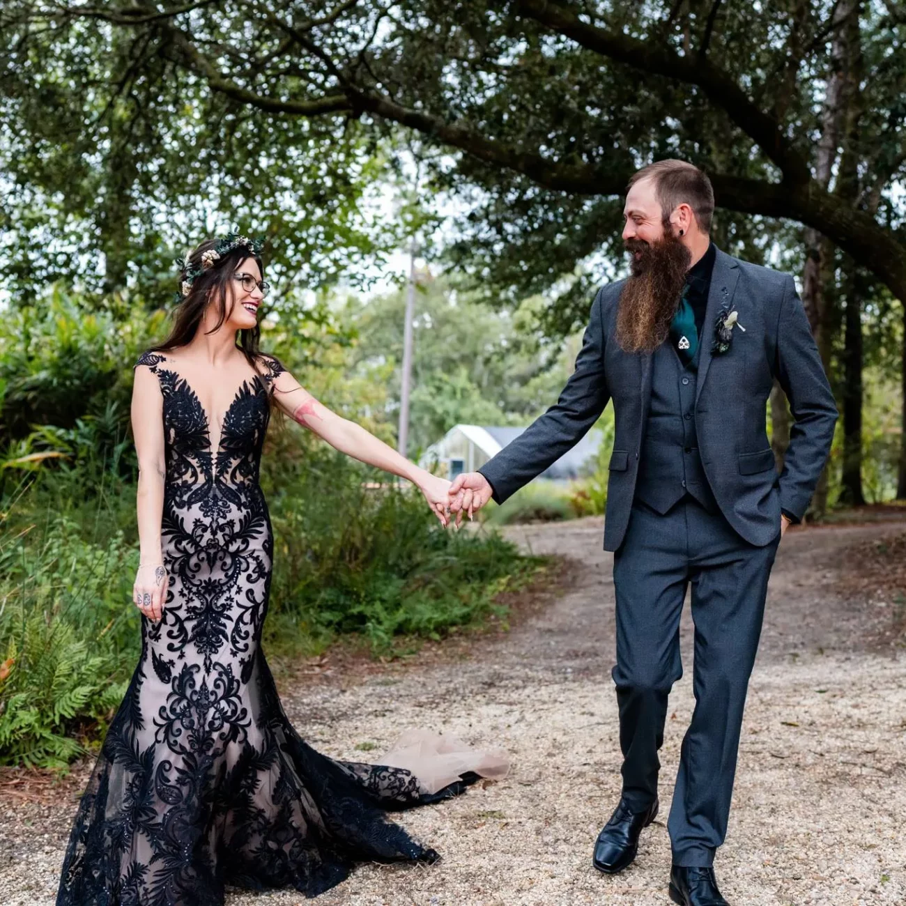 a man and woman holding hand Seth & Megan's Coldwater Gardens Wedding