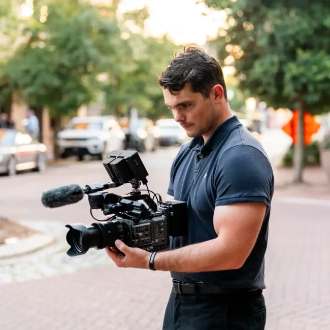 Korbin Henderson Owner of KDH Weddings holding video camera