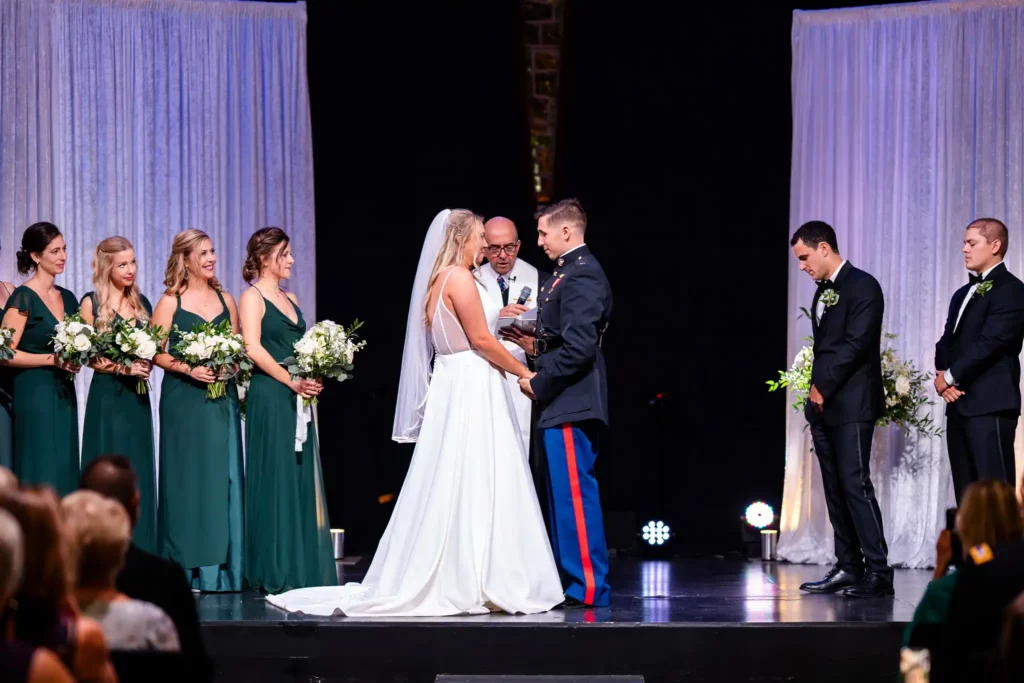 Planning a Military Wedding in Pensacola 2 usmc in dress blues holding hands with wife at the altar