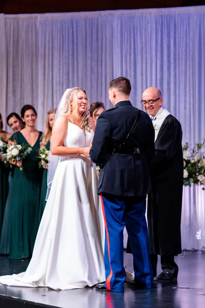 Planning a Military Wedding in Pensacola 1 usmc in dress blues holding hands with wife at the altar
