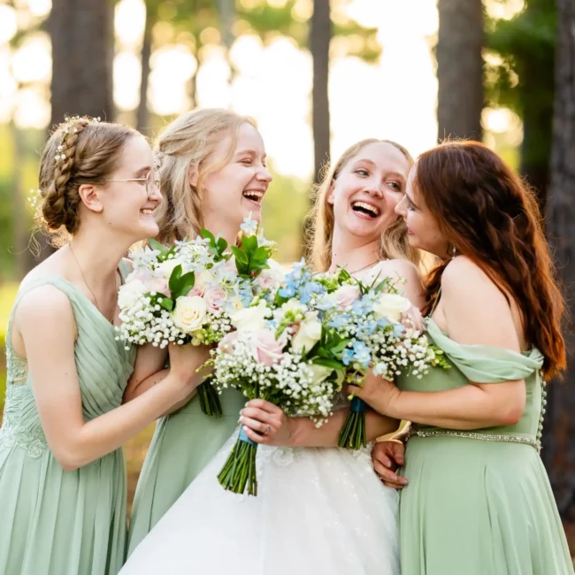 bridge and bridesmaids holding white flowers pink dresses and green dresses