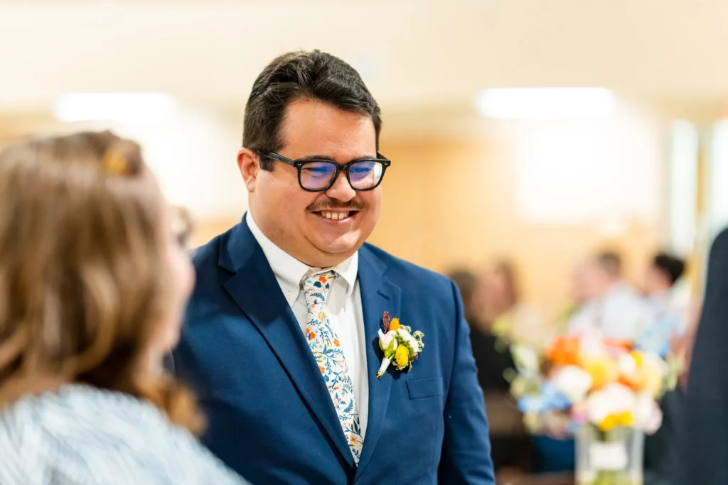 Groom smiling at alter during wedding in Semmes, AL