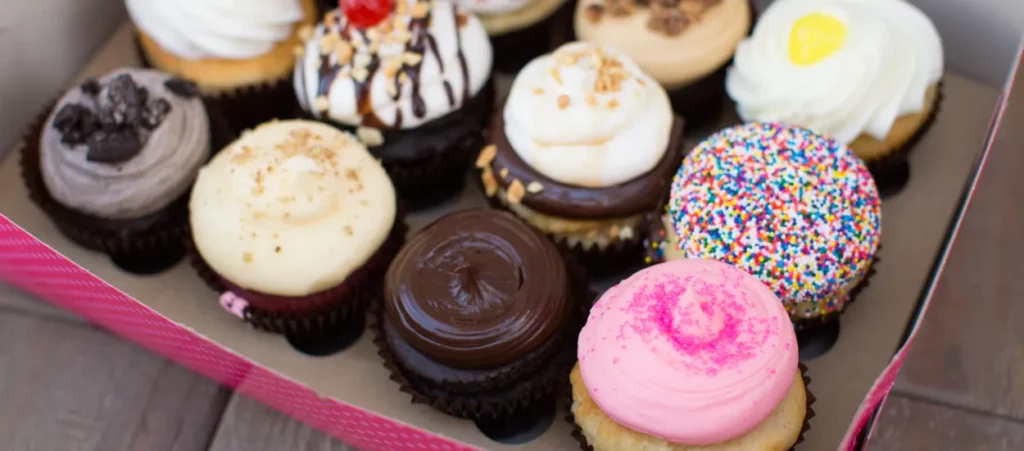 Destin Beach Wedding Photography Guide: Tips, Packages & FAQs 4 Smallcakes Cupcakery and Creamery bright colorful cupcakes in a box