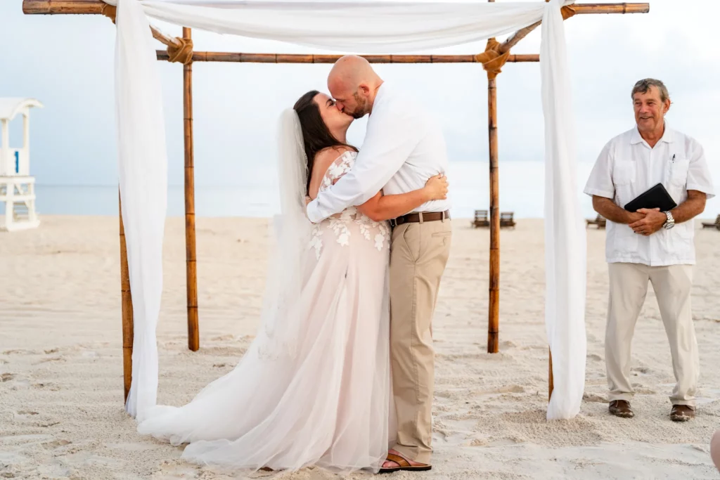 Chad & Rena's first kiss when just married under a canopy on Orange Beach