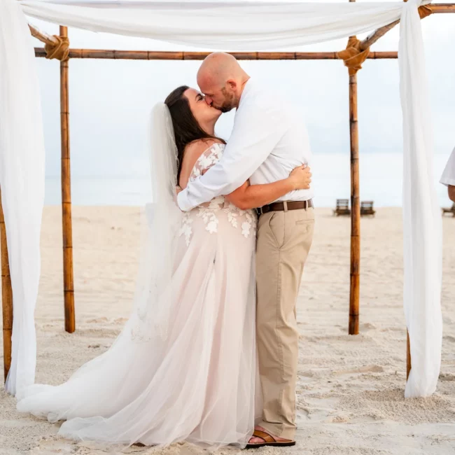 Chad & Rena's first kiss when just married under a canopy on Orange Beach