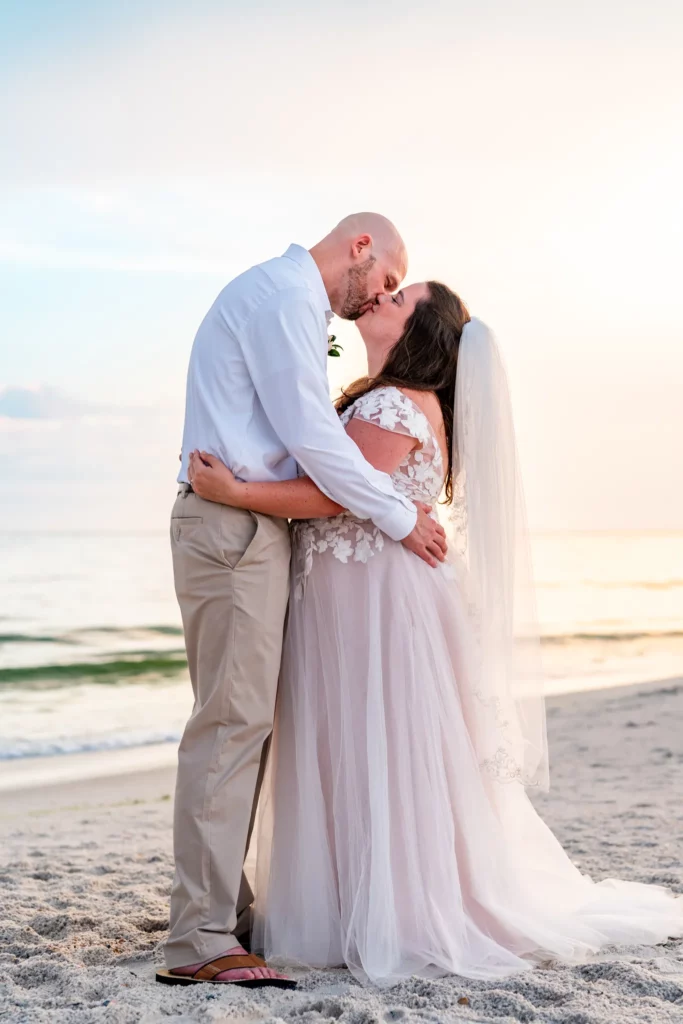 Panama City Beach Wedding Photographer 5 Chad & Rena kissing while standing on the beach after getting married on Orange Beach