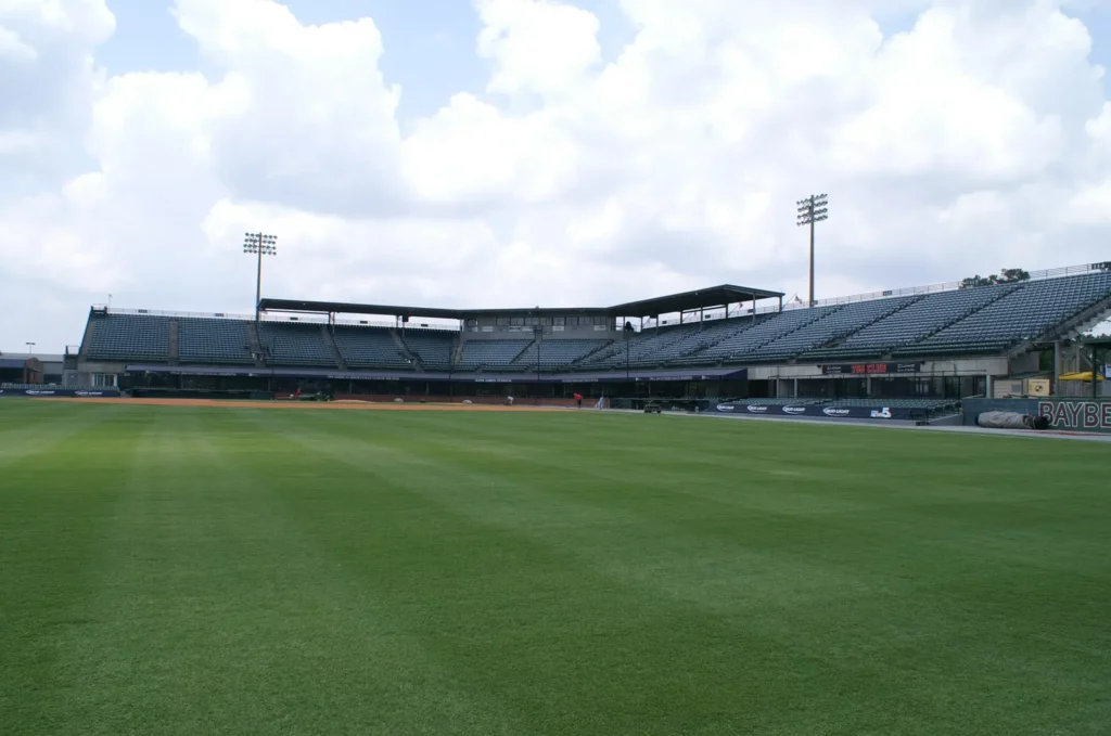 19 Best Engagement Photo Spots in Mobile, Alabama (With Parking, Timing & Real Session Examples) 16 Hank Aaron Stadium Mobile, AL. Outfield Walk. Empty soccer stadium with a freshly mowed green field, tiered grandstands, floodlights, and a bright, cloudy sky, creating a calm atmosphere.