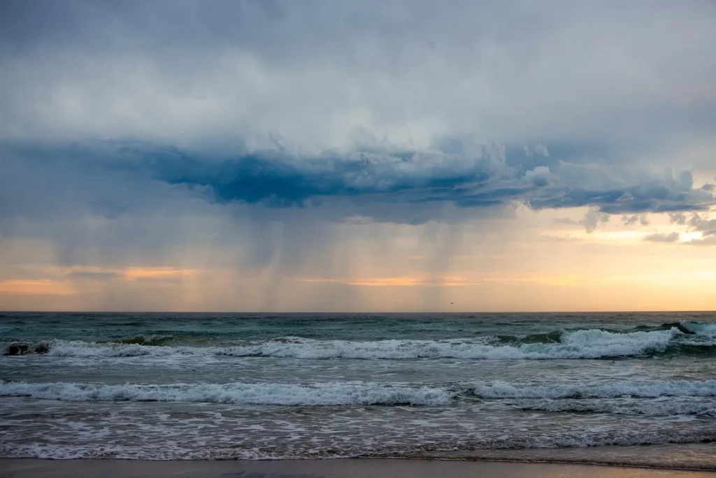 Dramatic storm clouds building over Gulf Coast beach before a summer afternoon thunderstorm