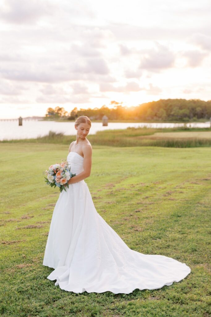 Jake & Lauren's Hurlburt Field Wedding on Santa Rosa Sound 8 Lauren with her peach and blue bouquet on the lawn by the Sound