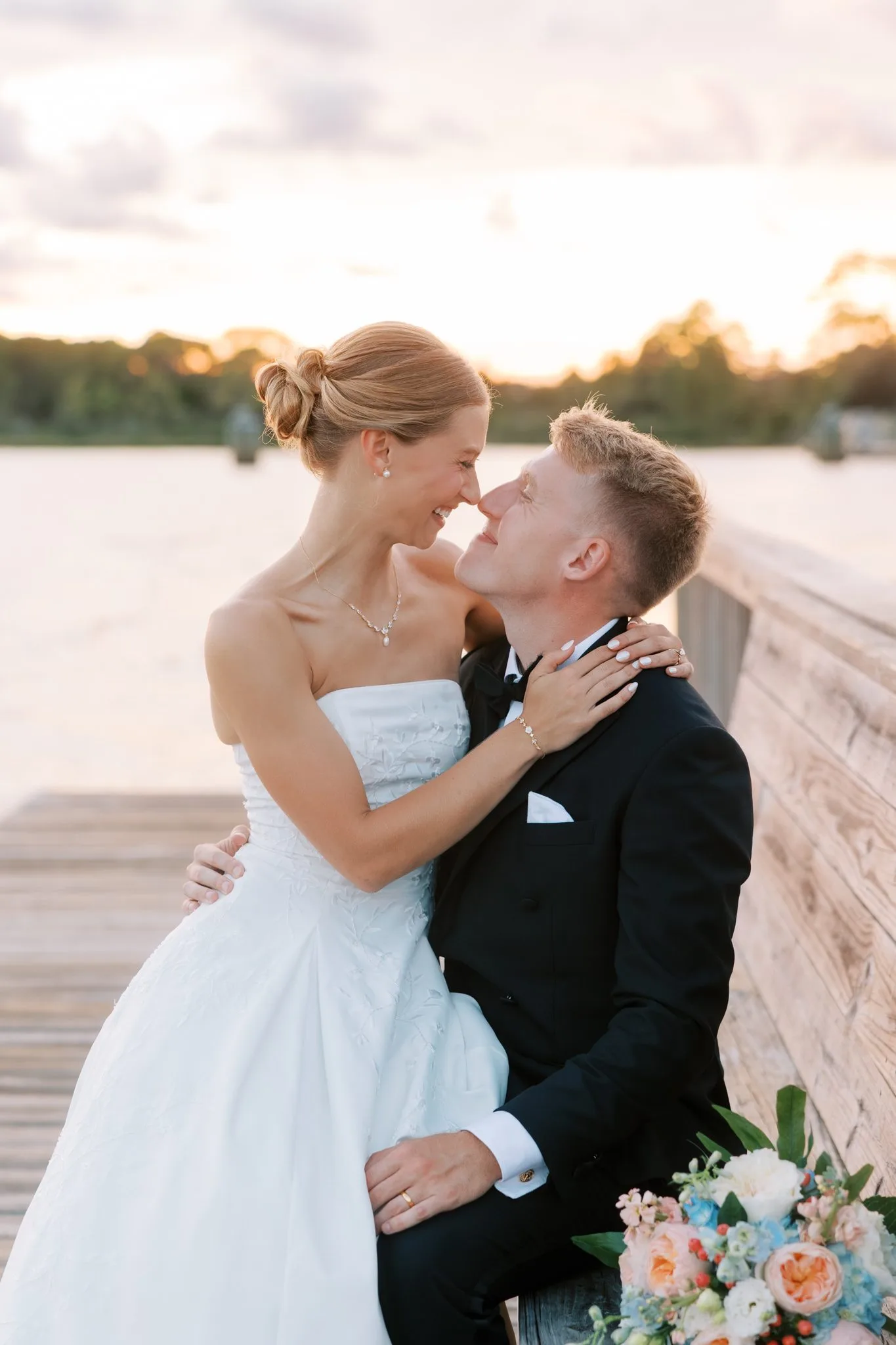 Pensacola Wedding Photographer - KDH Weddings 12 Lauren sits on Jake's lap on the dock at golden hour