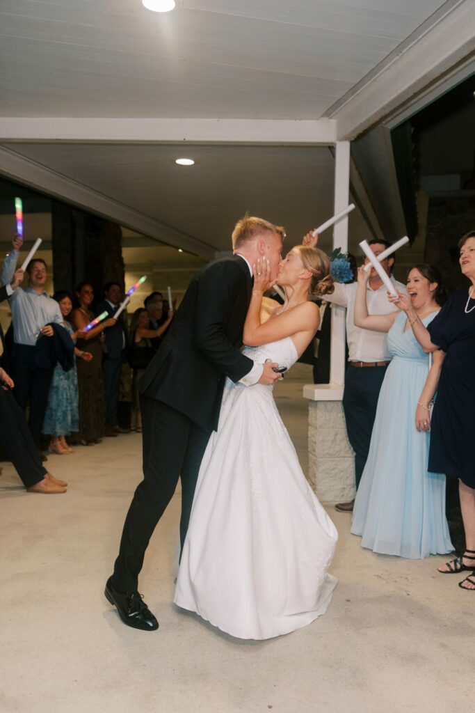 Jake & Lauren's Hurlburt Field Wedding on Santa Rosa Sound 13 Jake dips Lauren for a kiss during the glow-stick send-off