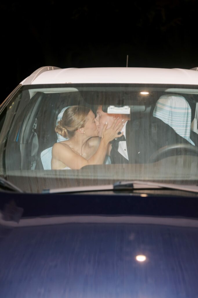 Jake & Lauren's Hurlburt Field Wedding on Santa Rosa Sound 14 Jake and Lauren kiss inside the getaway car at night