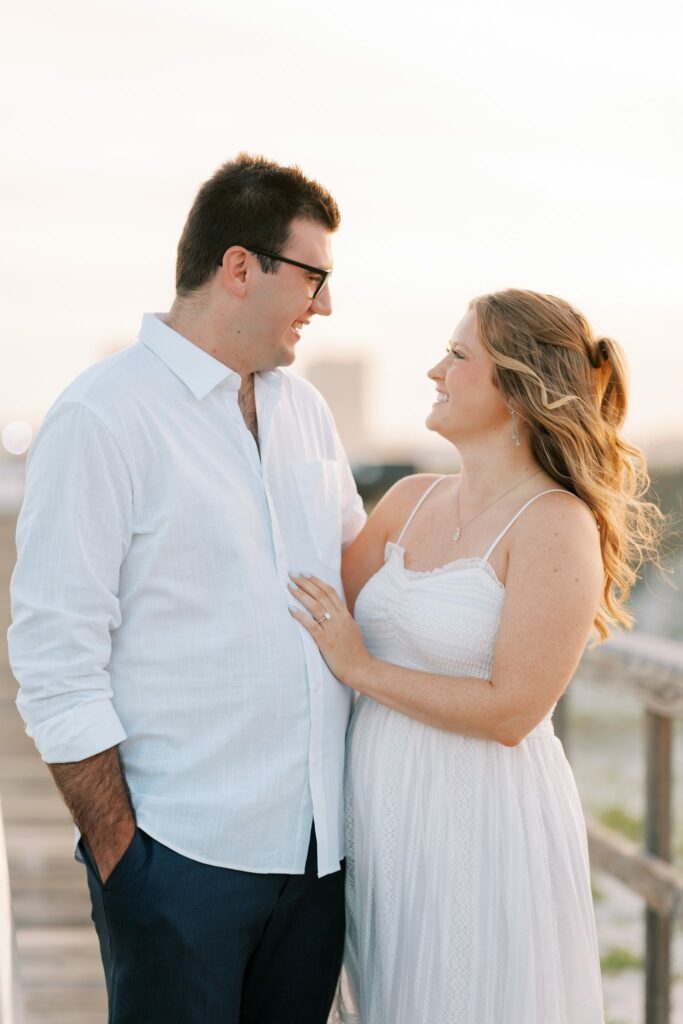 Andrew & Katie's Pensacola Beach Engagement Photos and Film 4 Portrait of Andrew and Katie by the beach boardwalk at sunset