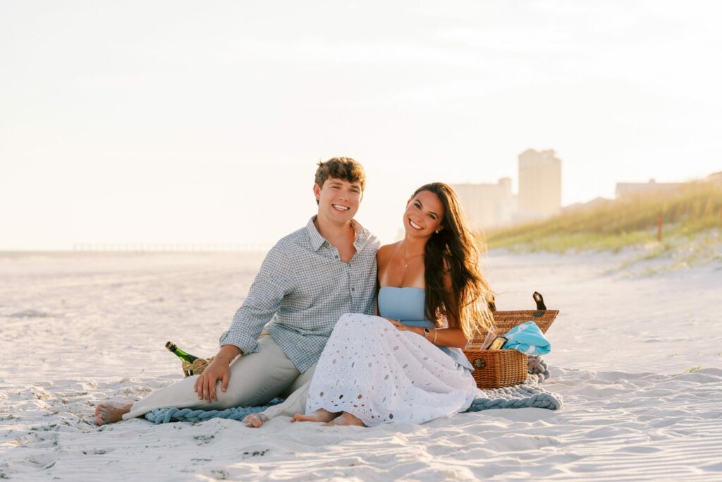 Hayes & Mallory's Surprise Proposal on Pensacola Beach 4 Newly engaged Hayes and Mallory on the picnic blanket at sunset on Pensacola Beach