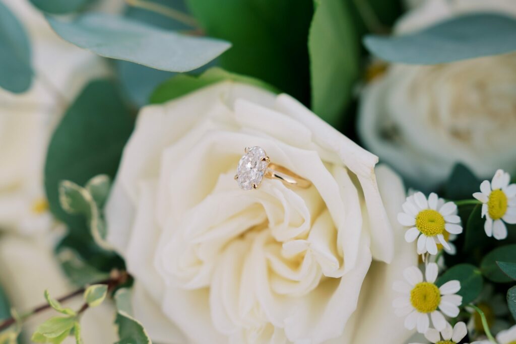 Hayes & Mallory's Surprise Proposal on Pensacola Beach 8 Mallory's engagement ring resting on a white garden rose