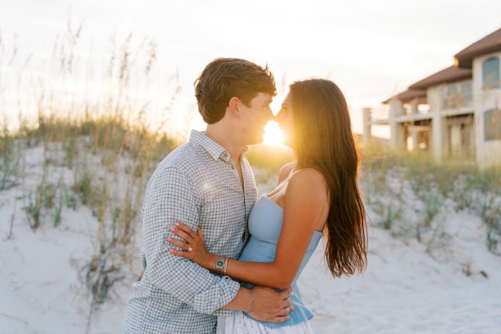 Hayes & Mallory's Surprise Proposal on Pensacola Beach 10 Hayes and Mallory embrace with the sun setting behind the dunes