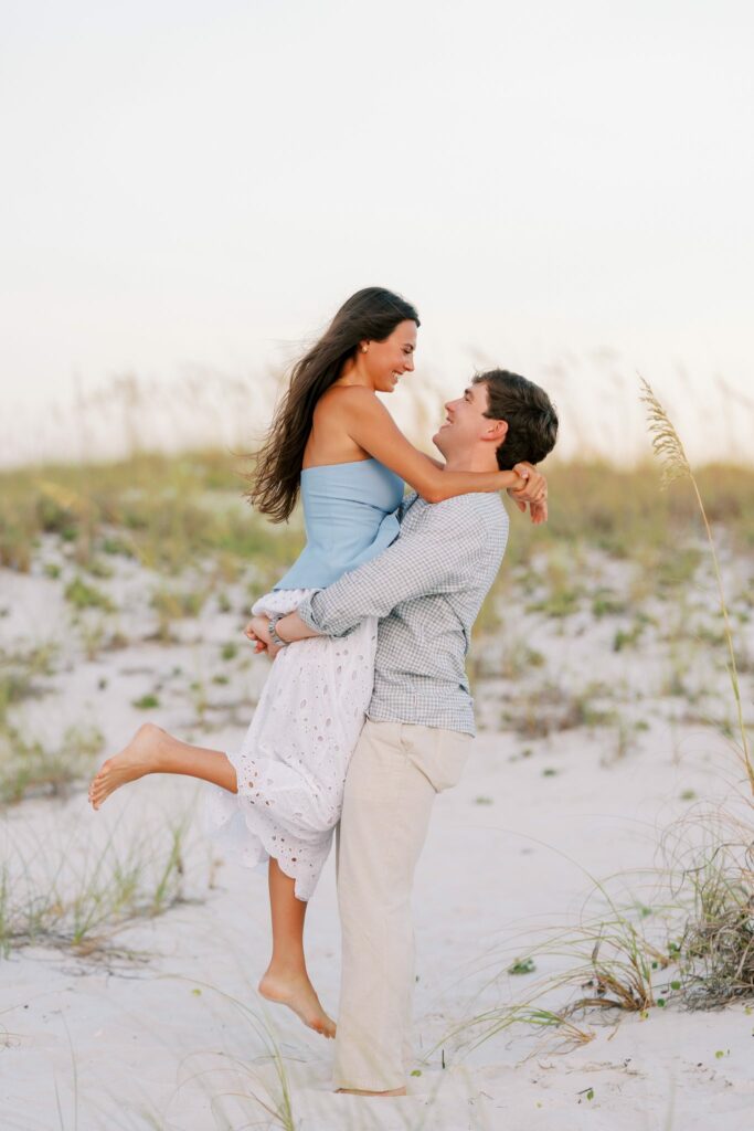 Hayes & Mallory's Surprise Proposal on Pensacola Beach 13 Mallory leaps into Hayes's arms in the dunes on Pensacola Beach