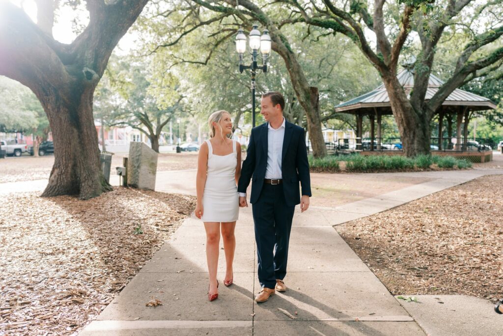 Sean and Brooklin walk a path past the gazebo in Seville Square