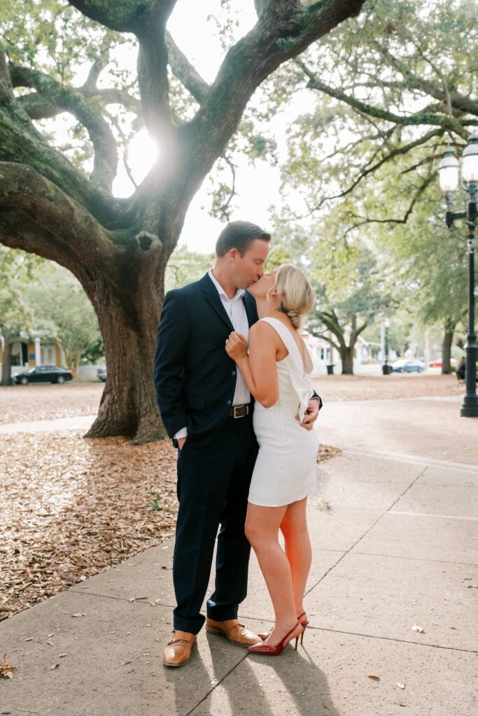 Sean kisses Brooklin's forehead under a live oak in Seville Square
