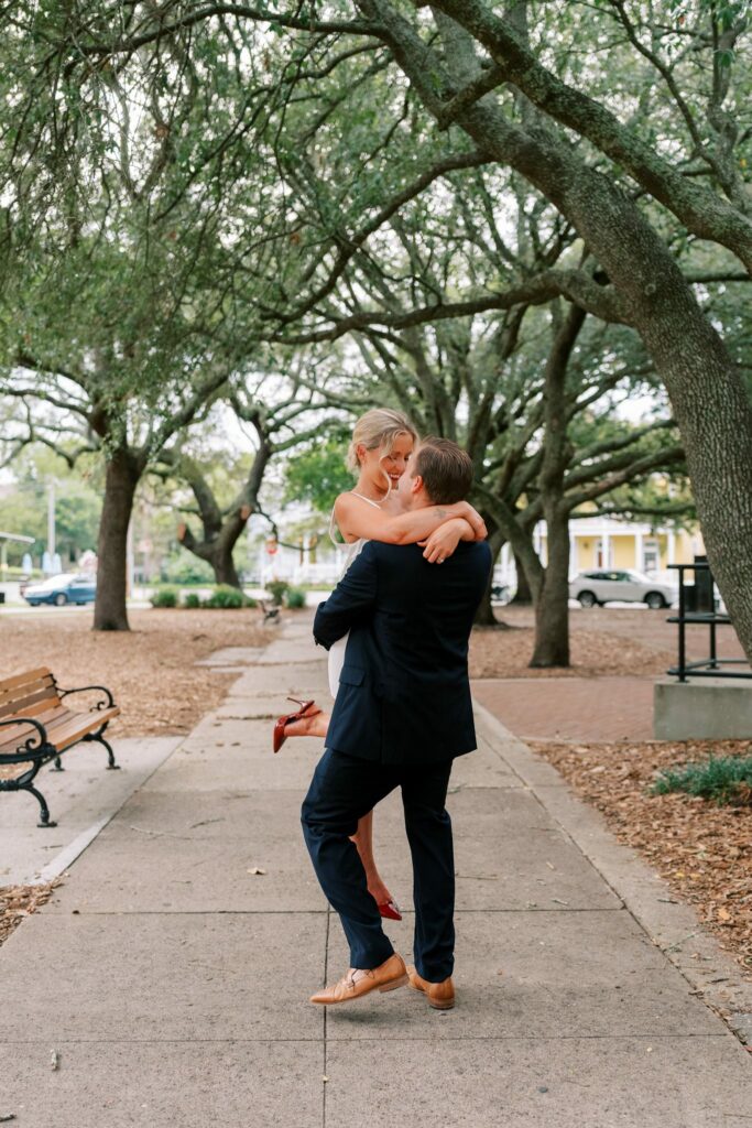 Sean lifts Brooklin on the brick path in Seville Square