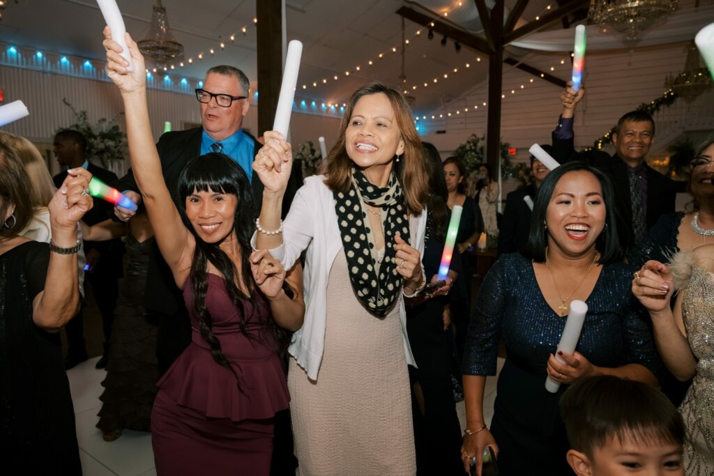 Bret & Ella's Spring Warehouse Wedding in Pensacola 10 Wedding guests dancing with glow sticks under string lights
