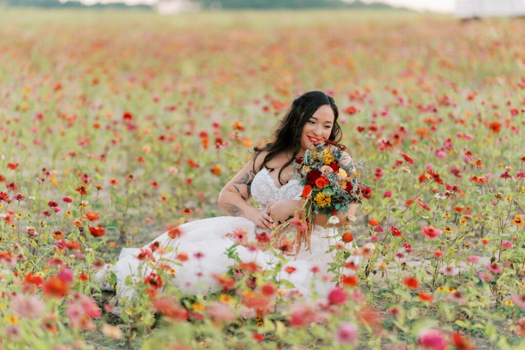Jacob & Angelina's Holland Farms Wedding 10 Angelina sitting in the Holland Farms flower field with her bouquet at Jacob and Angelina's wedding