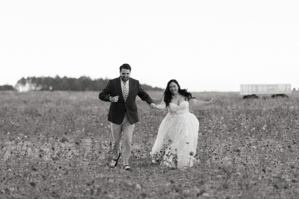 Jacob & Angelina's Holland Farms Wedding 11 Black and white photo of Jacob and Angelina walking through the Holland Farms flower field