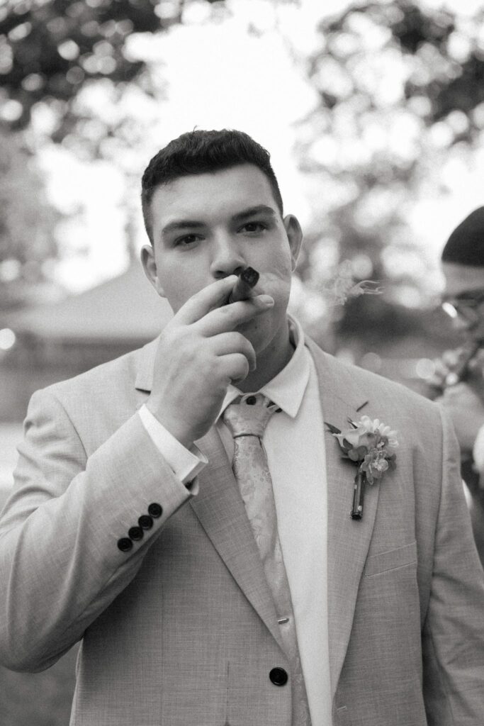 Brandon & Victoria's Laurel Hill Farm Wedding 6 Black and white photo of Brandon wiping away a tear during the ceremony