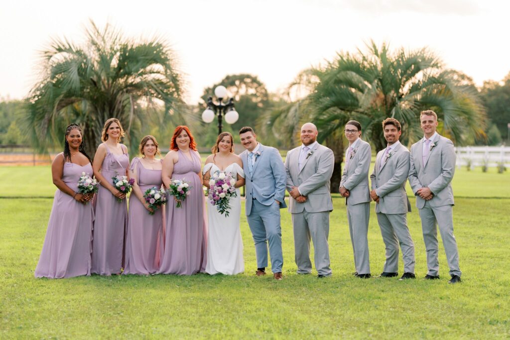 Brandon & Victoria's Laurel Hill Farm Wedding 7 Wedding party in lavender and gray on the palm-lined lawn at Laurel Hill Farm