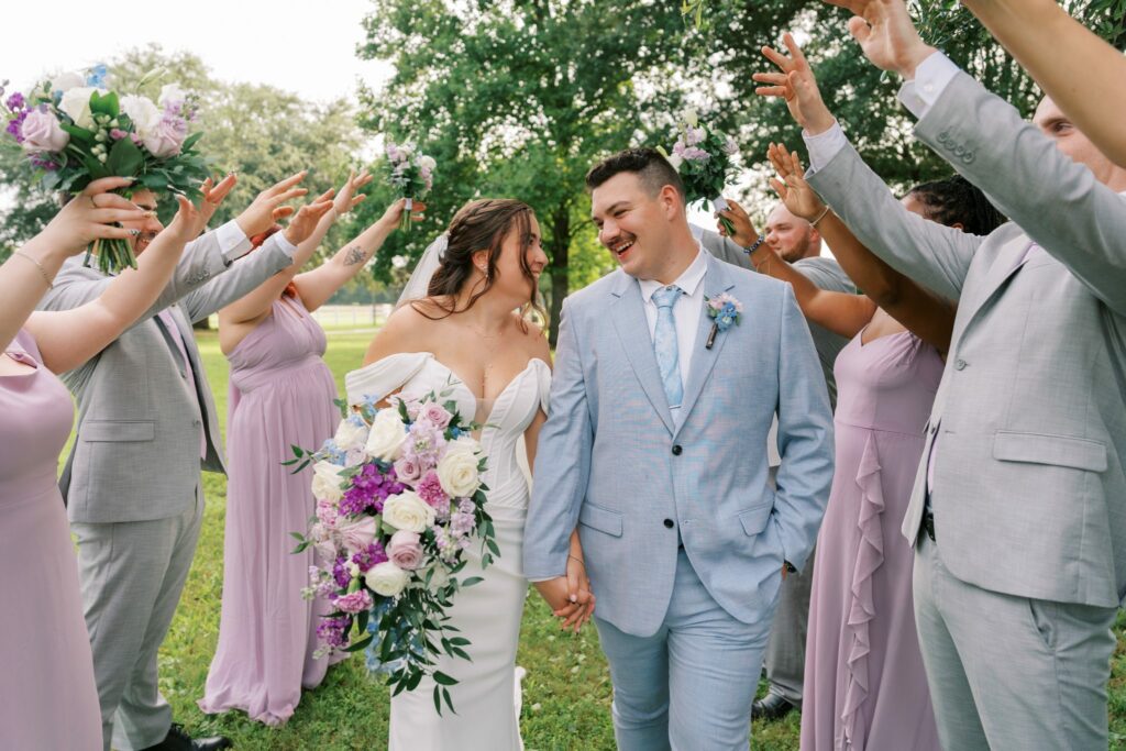 Brandon & Victoria's Laurel Hill Farm Wedding 8 Wedding party cheering Brandon and Victoria through a celebration tunnel