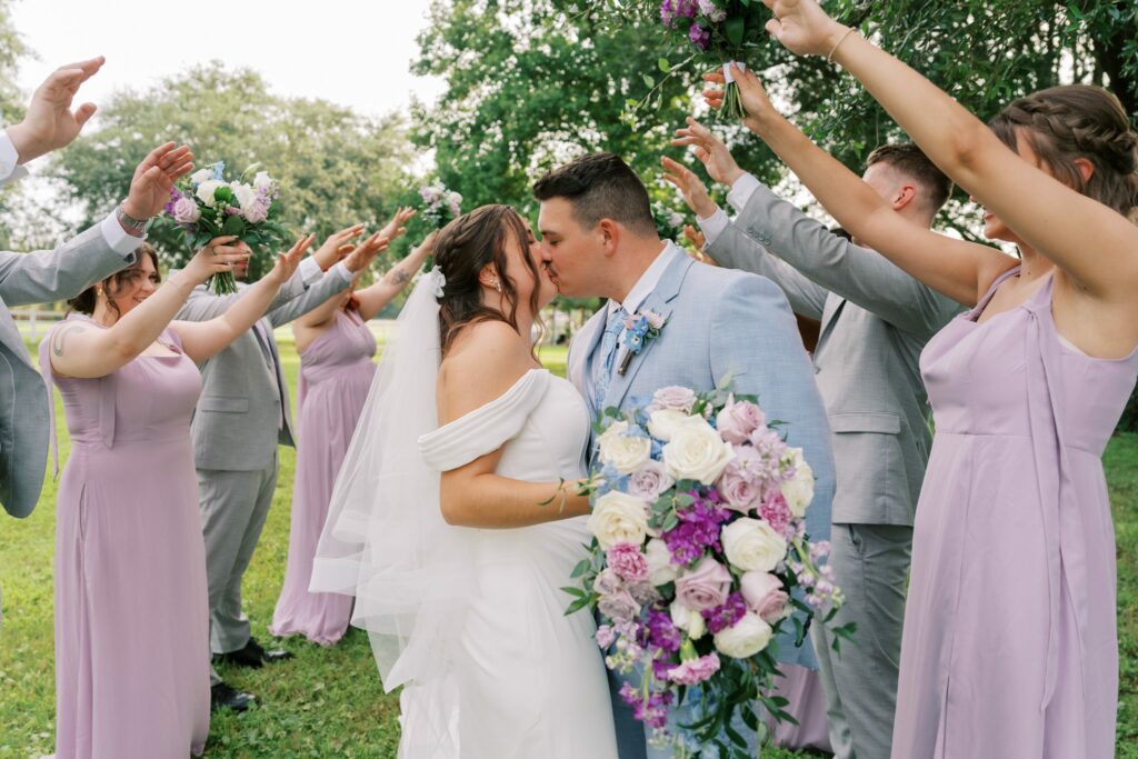 Brandon & Victoria's Laurel Hill Farm Wedding 9 Brandon and Victoria kiss as the wedding party cheers around them