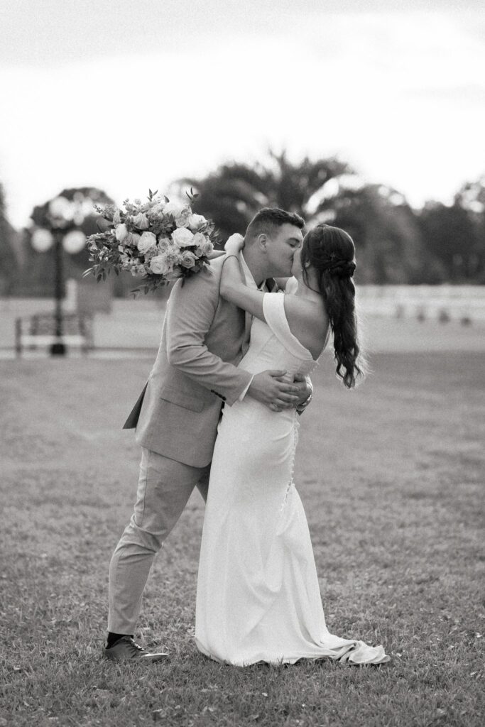 Brandon & Victoria's Laurel Hill Farm Wedding 10 Black and white photo of Brandon and Victoria kissing on the lawn at Laurel Hill Farm