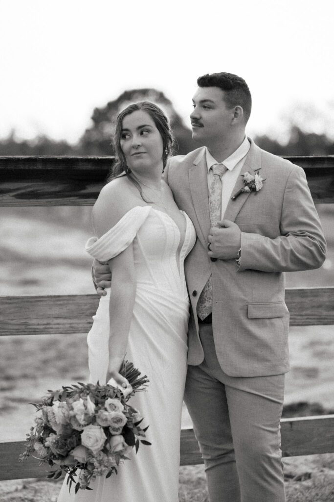 Brandon & Victoria's Laurel Hill Farm Wedding 11 Black and white portrait of Brandon and Victoria by the horse fence