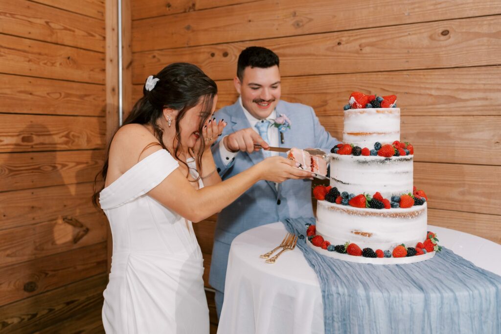 Brandon & Victoria's Laurel Hill Farm Wedding 16 Brandon and Victoria cut a naked cake topped with berries by Just Think Cake