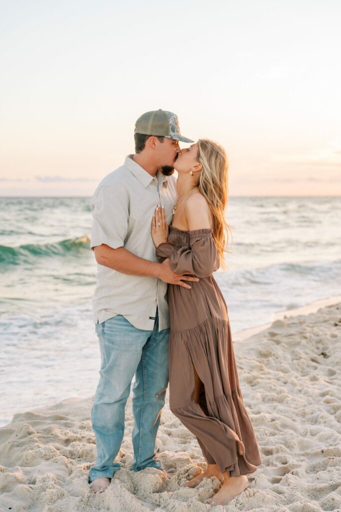 Avery & Hannah's Orange Beach Proposal 7 Avery and Hannah kiss at the edge of the surf on Orange Beach during their engagement session