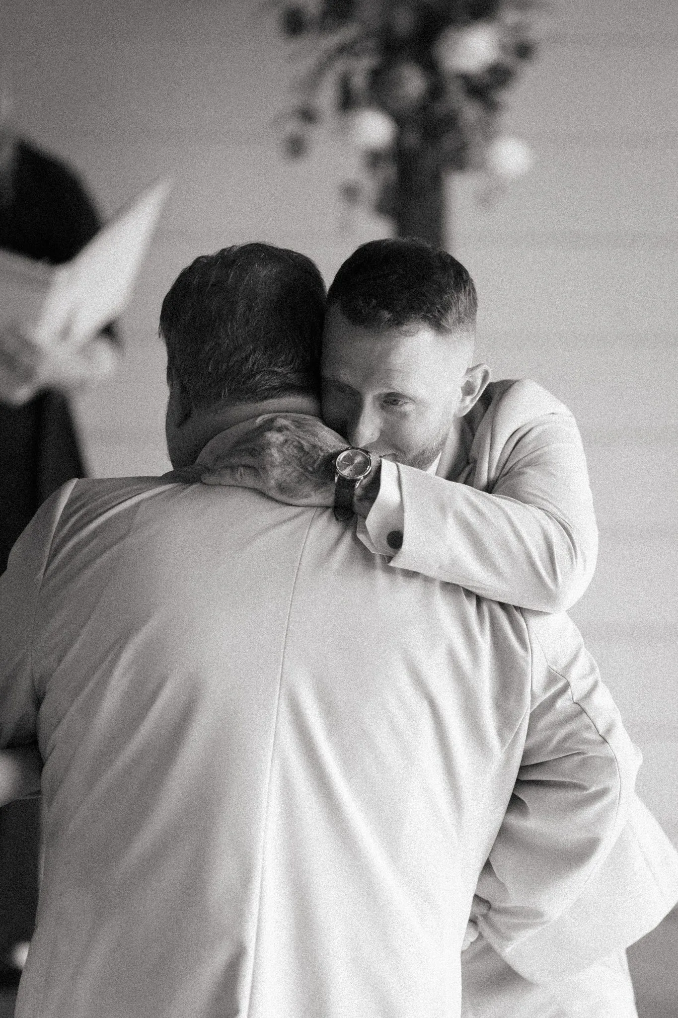 Pensacola Wedding Photographer - KDH Weddings 13 Black and white photo of Anthony in a long hug at his wedding ceremony at The Venue at Hidden Falls
