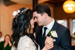 Jacob & Samantha’s Unforgettable Wedding at Avenue D Events in Birmingham, AL 29 a man and woman holding hands sharing first dance at wedding at Navarre Beach Wedding House