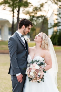 Caleb & Jordan’s Unforgettable Wedding in Navarre, FL 71 a man and woman in wedding attire looking into each others eyes in Navarre, FL - KDH Weddings