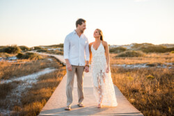 Pensacola Engagement Photography: A Dreamy Fort Pickens Session with Ryan & Kinsie 24 a man and woman holding hands on a wooden path Dreamy Engagement Photos at Fort Pickens