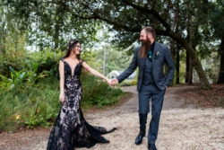 A Hauntingly Beautiful Celebration: Seth and Megan's Enchanting Coldwater Gardens Wedding 32 a man and woman holding hand Seth & Megan's Coldwater Gardens Wedding