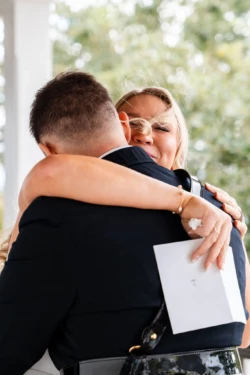 A Perfect USMC Wedding in Pensacola – Bobby & Kaisey’s Big Day 23 groom in dress blues first look at bride hugging