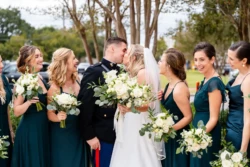 A Perfect USMC Wedding in Pensacola – Bobby & Kaisey’s Big Day 24 first kiss between husband and wife, husband in usmc dress blues, wife in white full length wedding dress