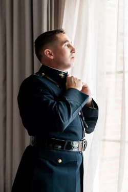 A Perfect USMC Wedding in Pensacola – Bobby & Kaisey’s Big Day 27 usmc in dress blues fixing collar looking out a window