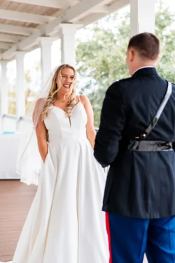 A Perfect USMC Wedding in Pensacola – Bobby & Kaisey’s Big Day 28 groom in dress blues first look at bride in white dress