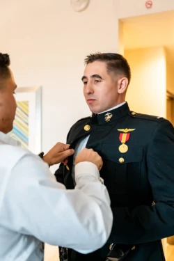 A Perfect USMC Wedding in Pensacola – Bobby & Kaisey’s Big Day 13 man helping groom in usmc dress blues before wedding